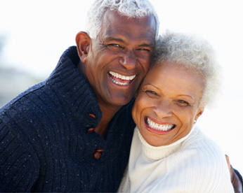 couple hugging and smiling at camera